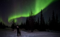Snowshoeing under northern lights