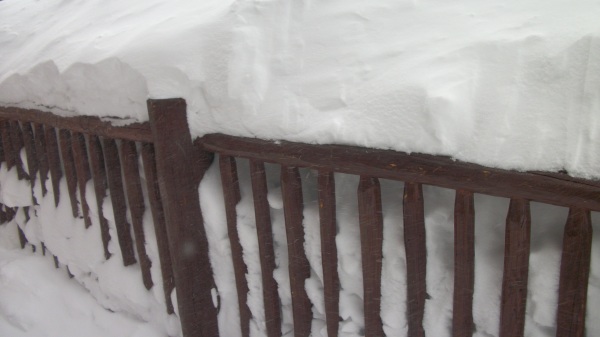 Breckenridge hut railing with multiple feet of snow