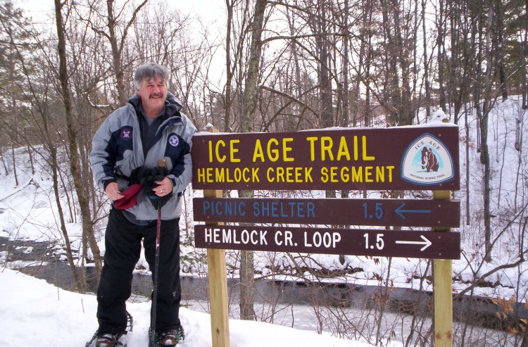 snowshoe bucket list Ice Age Trail: man with snowshoes near trail sign