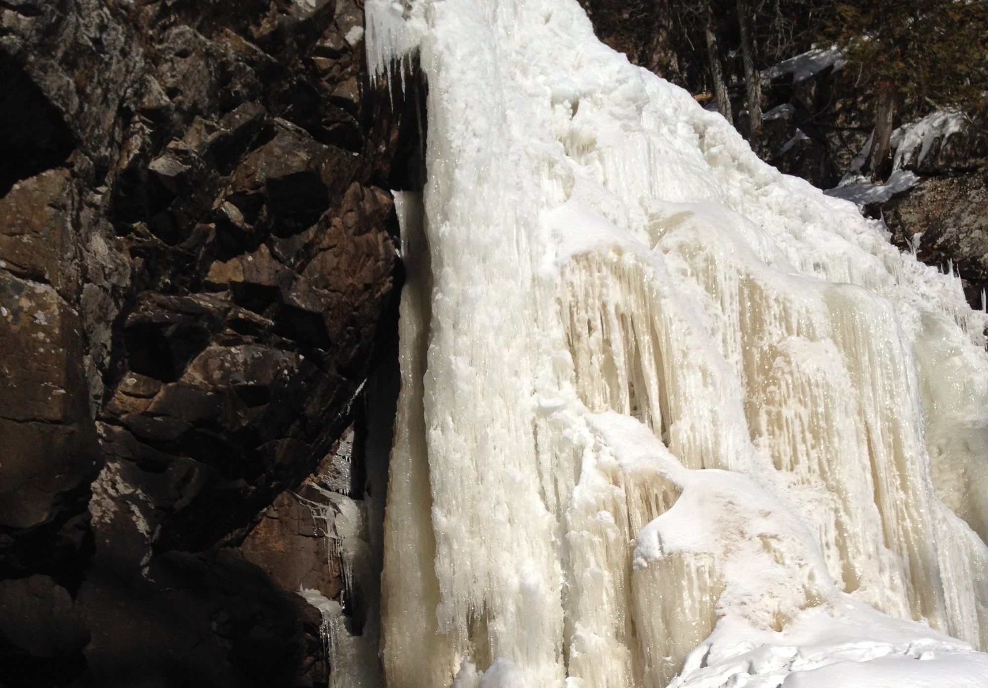 snowshoeing Lanaudiere region, Quebec: frozen waterfall at Chute-A-Bull Regional Park in Quebec