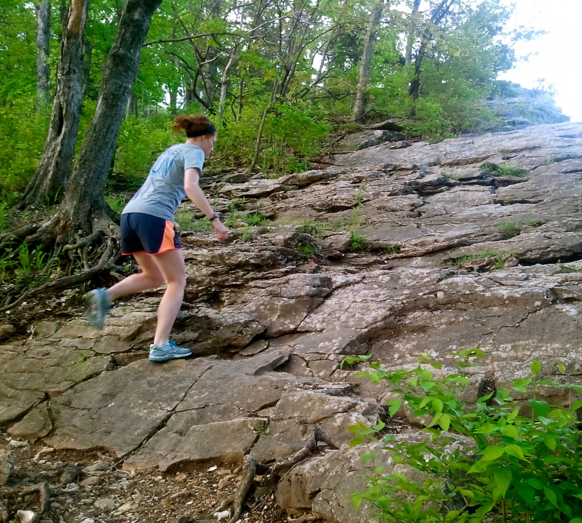 woman running up hill in summer
