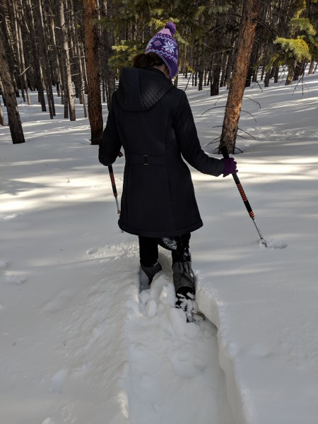 snowshoeing tips for choosing snowshoes: woman in snow sinking to knees on snowshoes