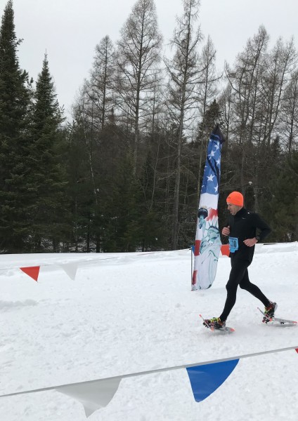 snowshoe racer crossing the finish line