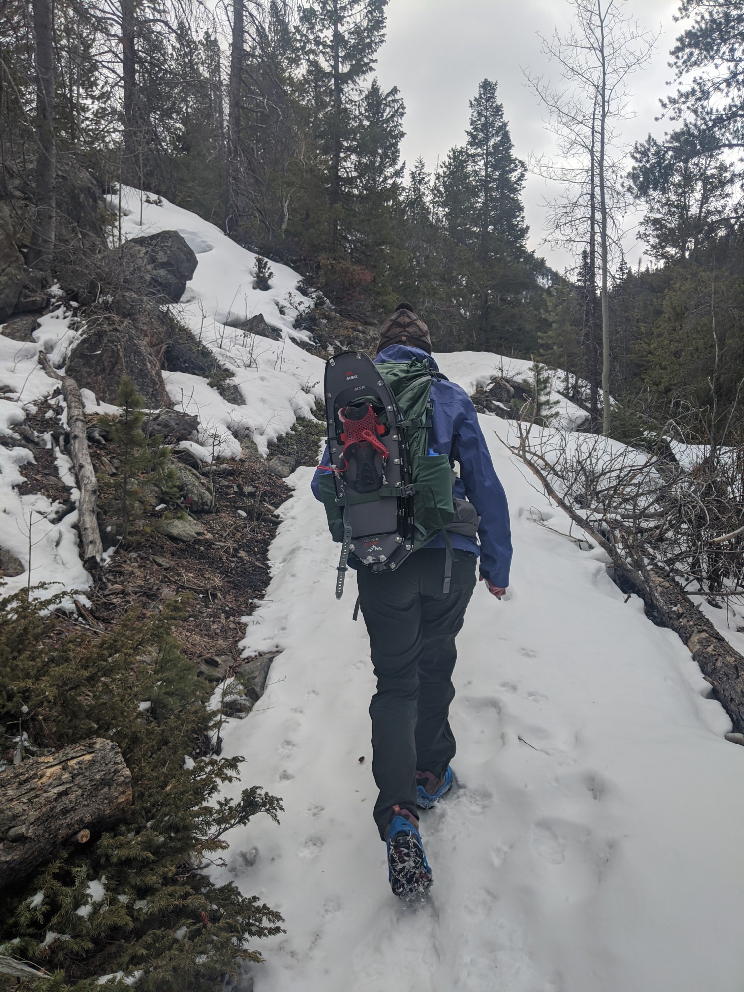 Yaktrax reviews: woman climbing hill will Yaktrax traction devices