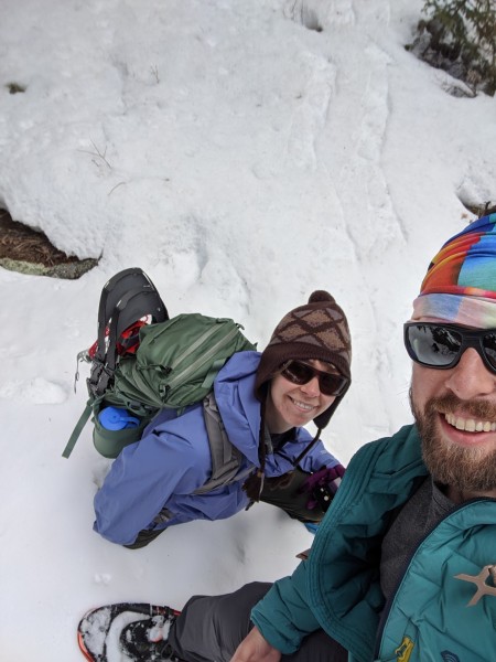 selfie of man and woman on snowshoe hike
