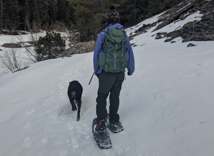 woman and dog snowshoeing with Lightning Ascents