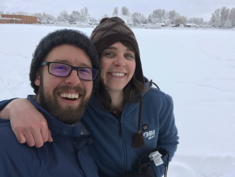 couple posing in park while snowshoeing