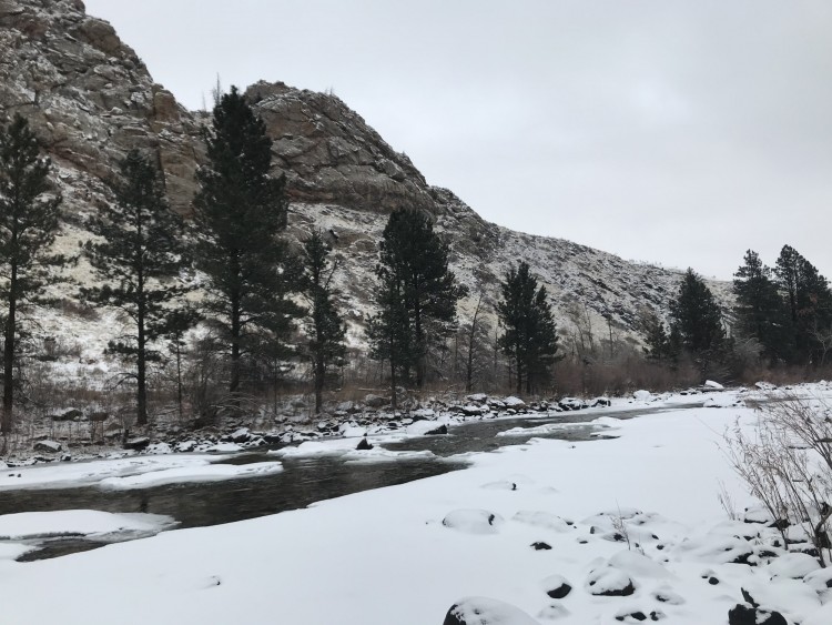 snow, river, and hill in background