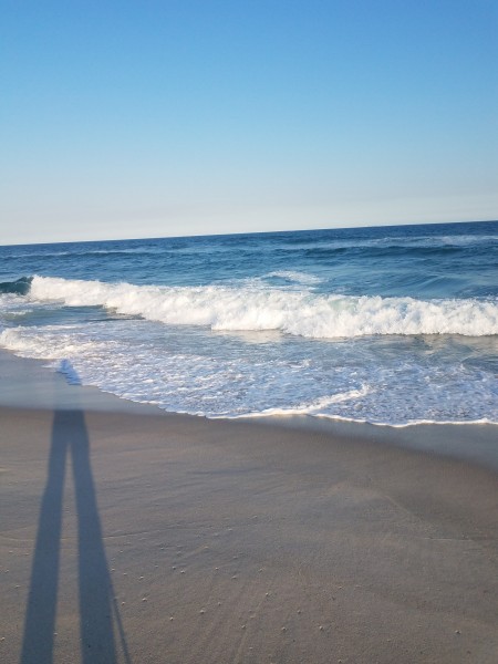 shadow on the beach with waves in background