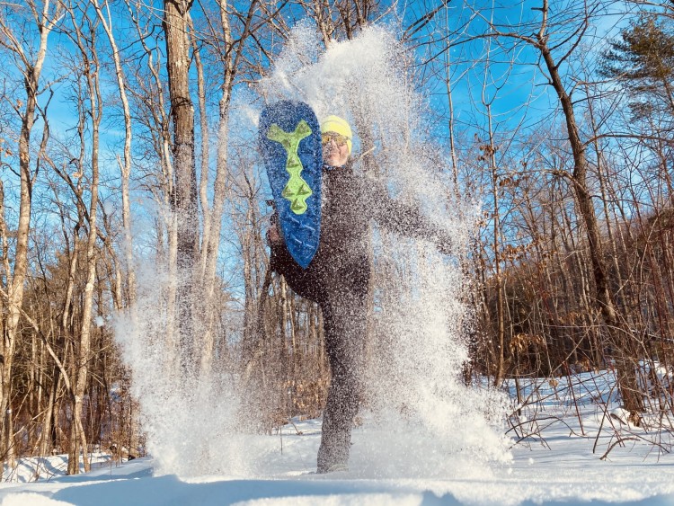 winter photo competition: person throwing snowshoe in the air with snow