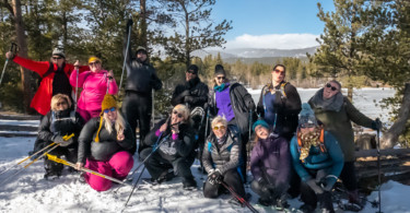 group photo of participants at WNDRoutdoors size inclusive snowshoeing event