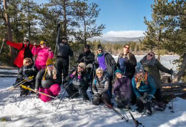 group photo of participants at WNDRoutdoors size inclusive snowshoeing event
