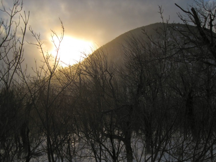 sun setting over the Catskill High Peaks in winter