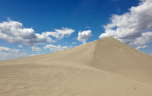 dune with blue sky and clouds