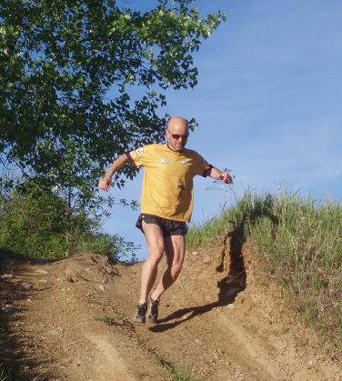 man running downhill on a trail