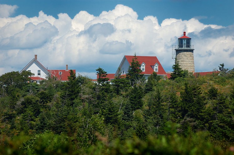 Lighthouse and Museum on Monhegan Island with trees in foreground