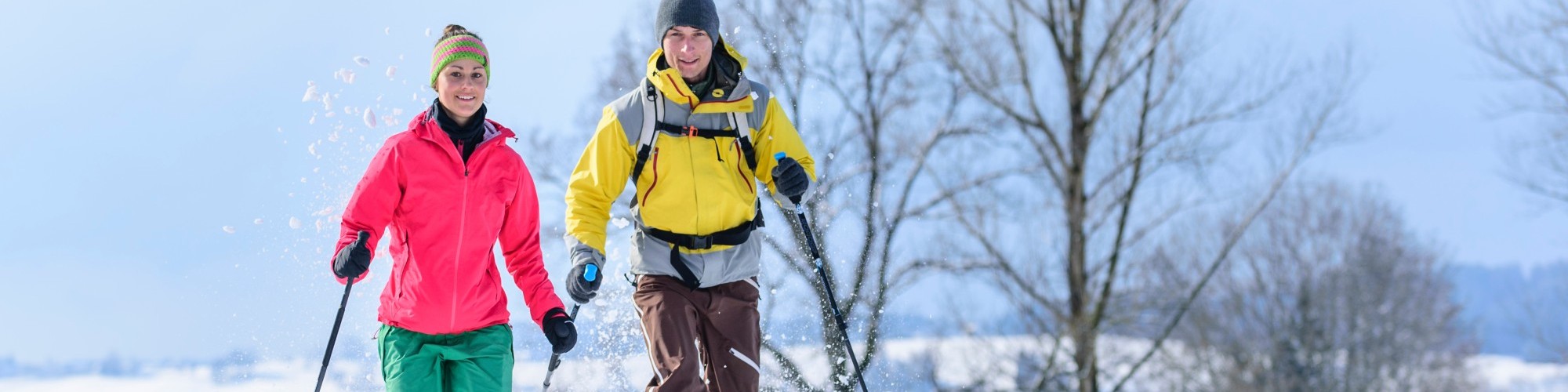 Two snowshoers running in deep snow