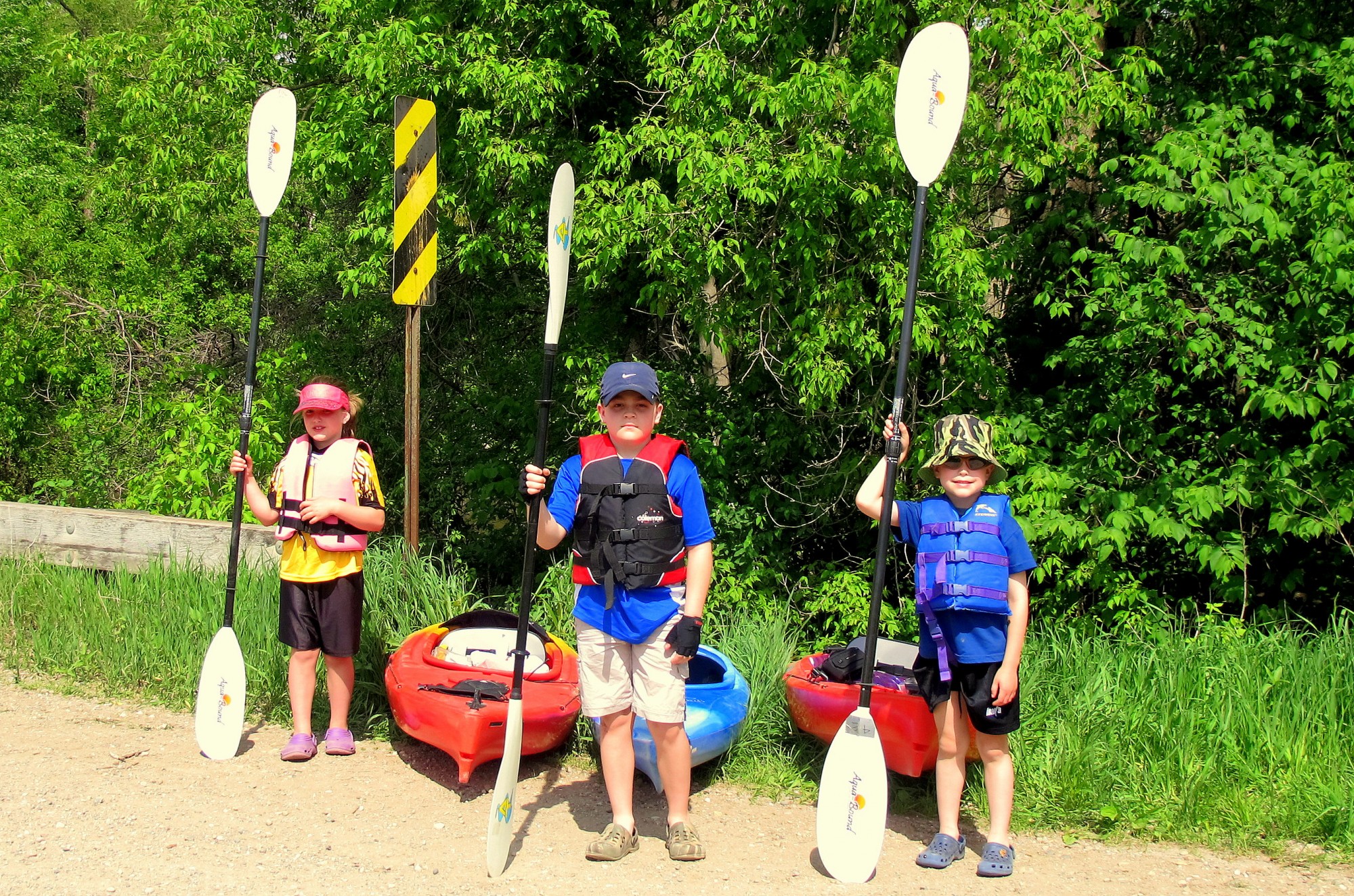 kids standing by kayaks for mothers day kayaking