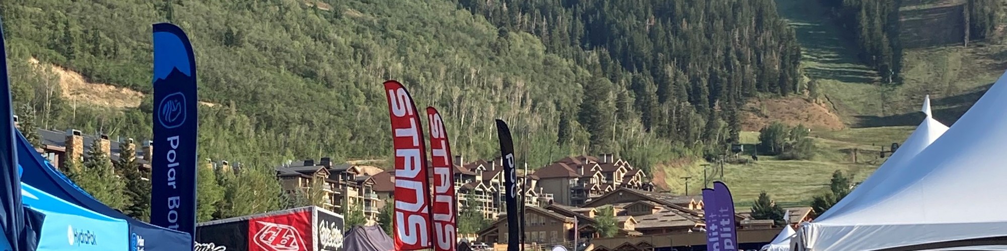 brand tents in rows with mountains in background