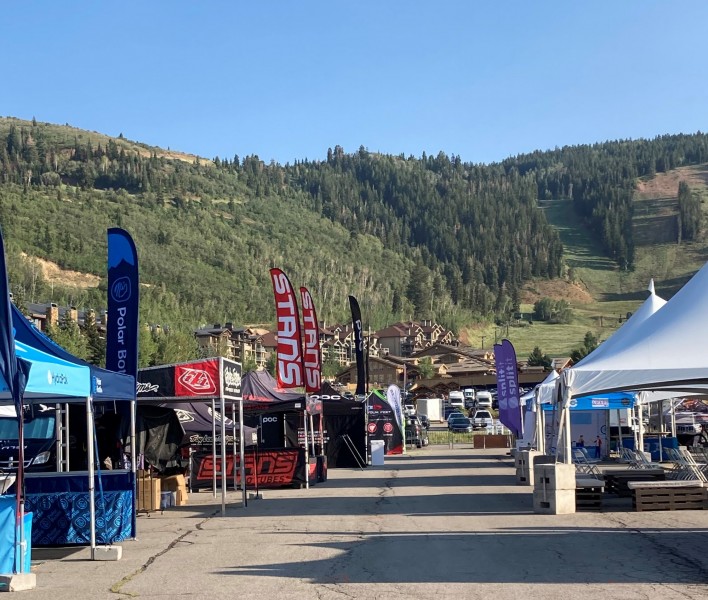 brand tents in rows with mountains in background