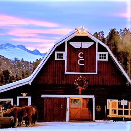 barn and horses with mountain background at C Lazy U Ranch