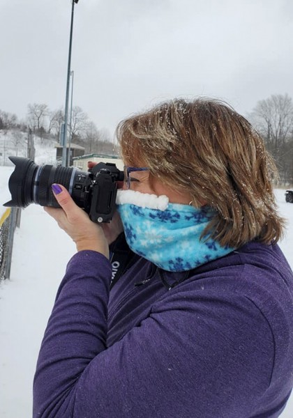 woman with camera wearing Cozy Nose
