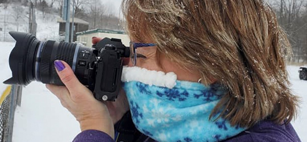 woman wearing Cozy Noze while taking a photo