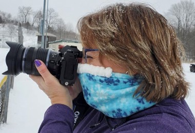 woman wearing Cozy Noze while taking a photo