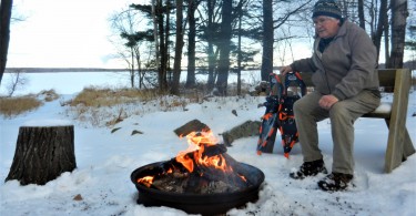 man at campfire in winter