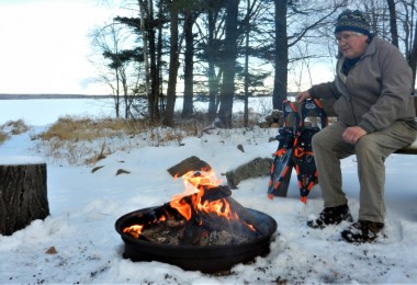 man at campfire in winter