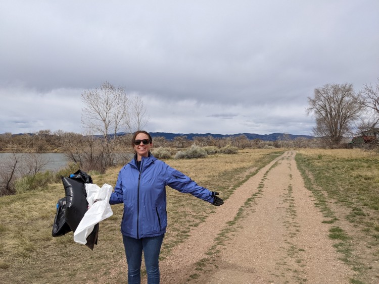 person with trash bags on trail