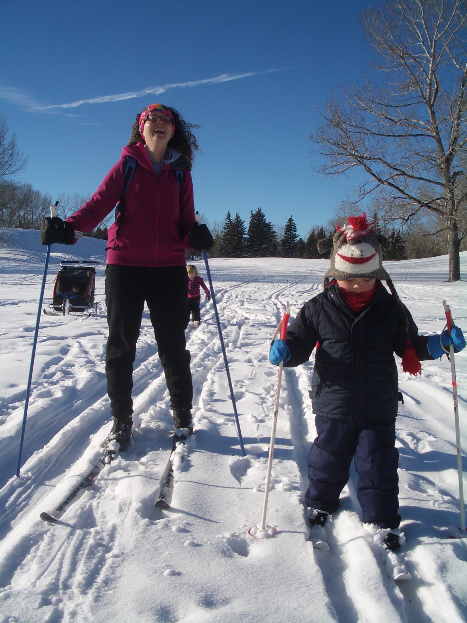 outdoor winter activities ideas: mom and son cross country skiing on a golf course