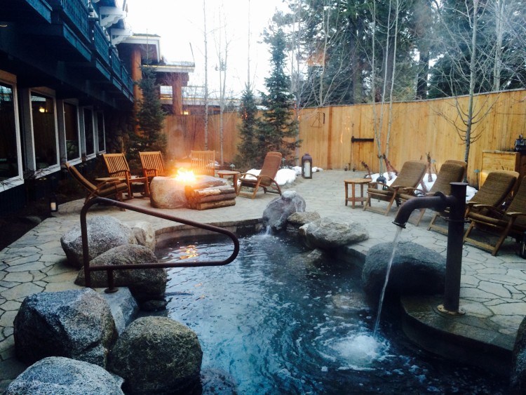 outdoor hot tub with lounge chairs in background at Cove Spa