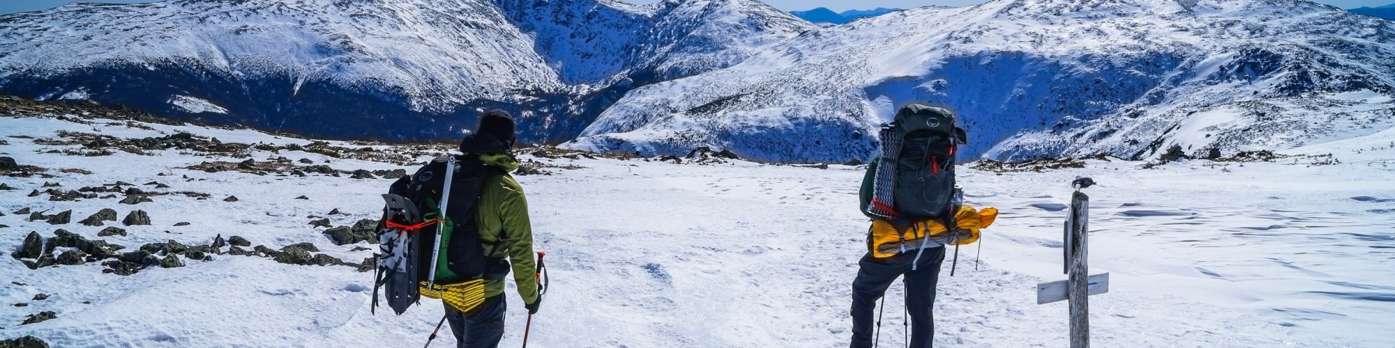 two people looking at snowy mountain in distance