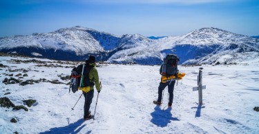 two people looking at snowy mountain in distance