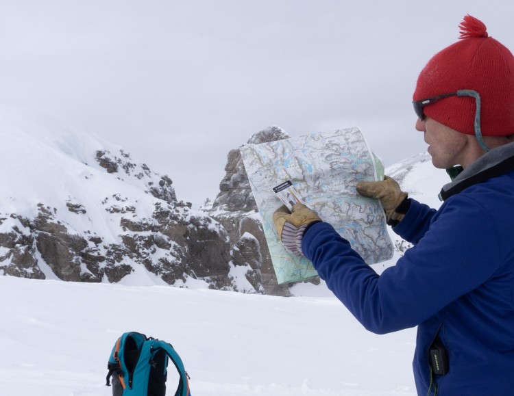person looking at a map on the trail