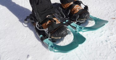 close up of snowshoes and bindings on snow