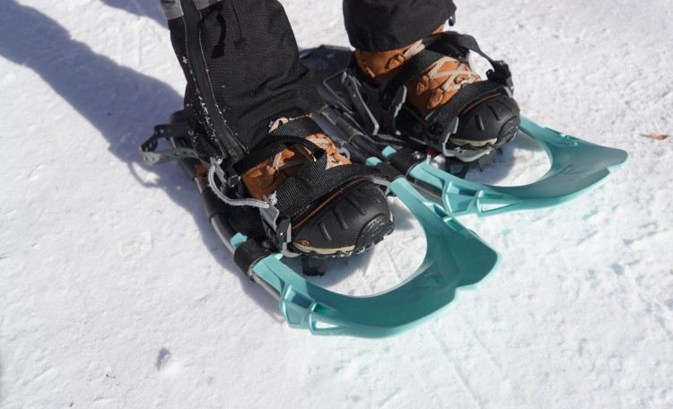snowshoeing footwear: close up of snowshoes and bindings on snow