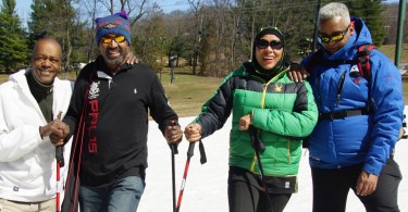 featured photo: four snowshoers posing- cropped