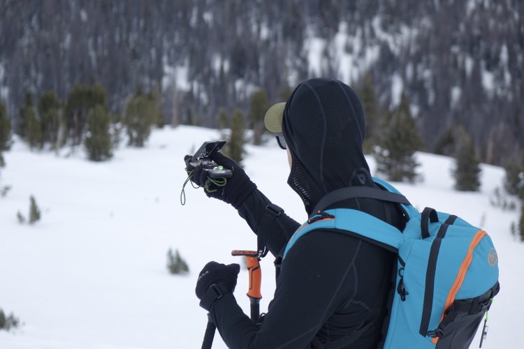 person looking at their compass on the trail