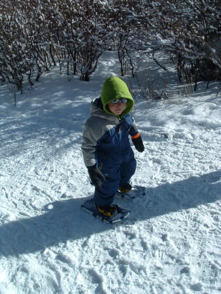 snowshoeing tips for kids: child wearing snowshoes