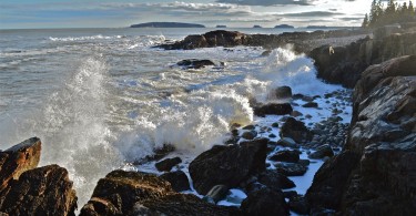 waves crashing along a rocky coastline in Maine