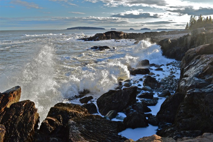 waves crashing along a rocky coastline in Maine