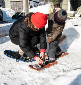 Always eager to learn, Jack watches me strap on his new snowshoes. 