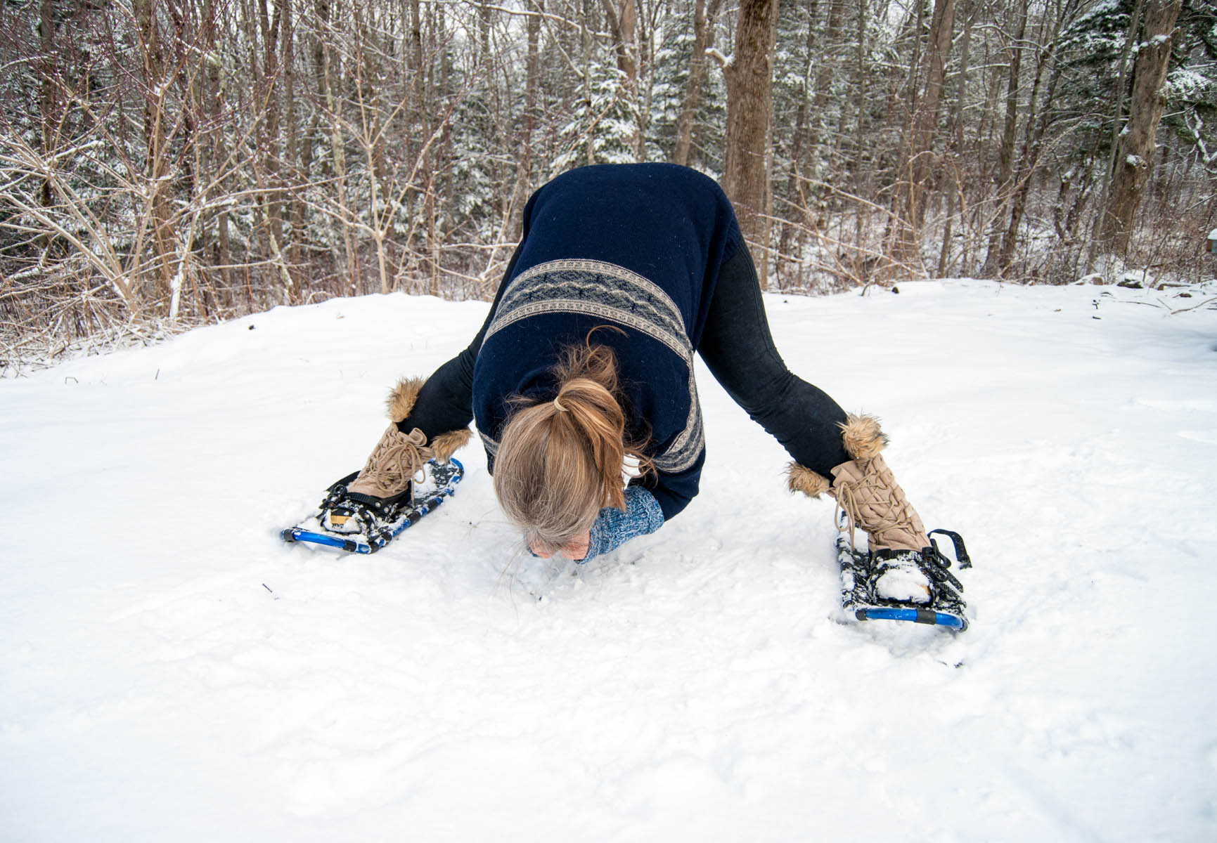 Wide forward fold, yoga outside in the snow
