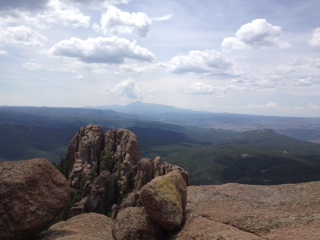 scenic photo of rocks in foreground with mountains in distance