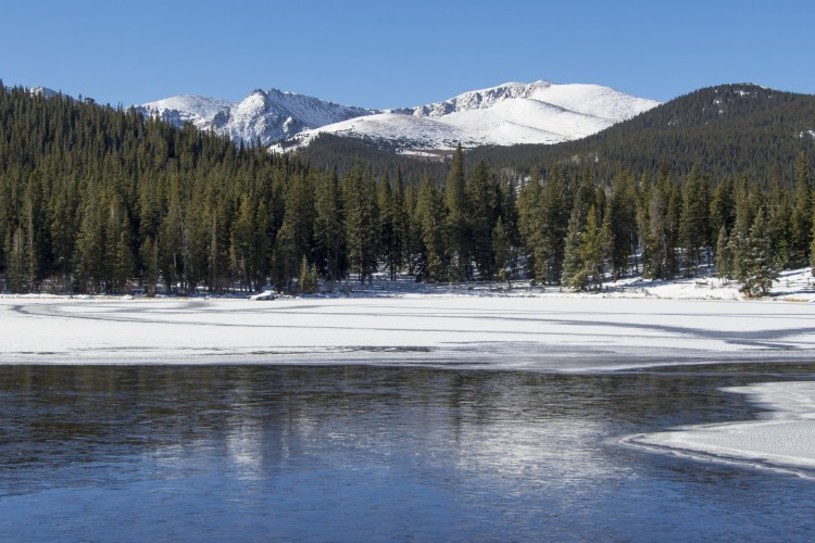 snowshoeing near denver co: echo lake with ice and mountains in trees in background