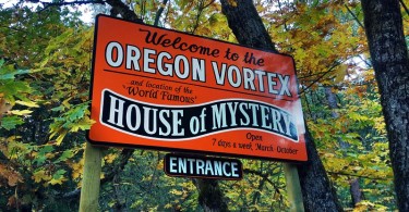 sign for the House of Mystery with trees in background