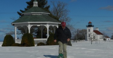 man snowshoeing from gazebo in Ludington Park