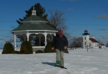 man snowshoeing from gazebo in Ludington Park